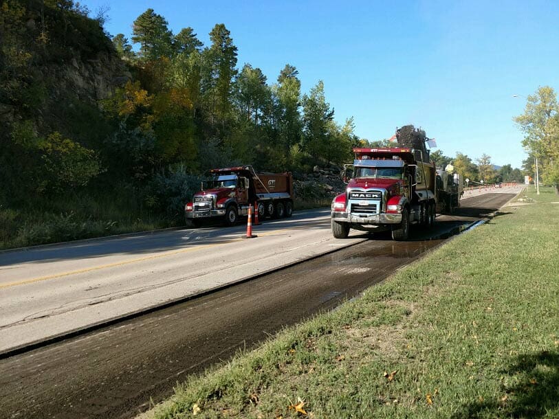 GTI Companies, Inc dump trucks being used for roadway paving restoration